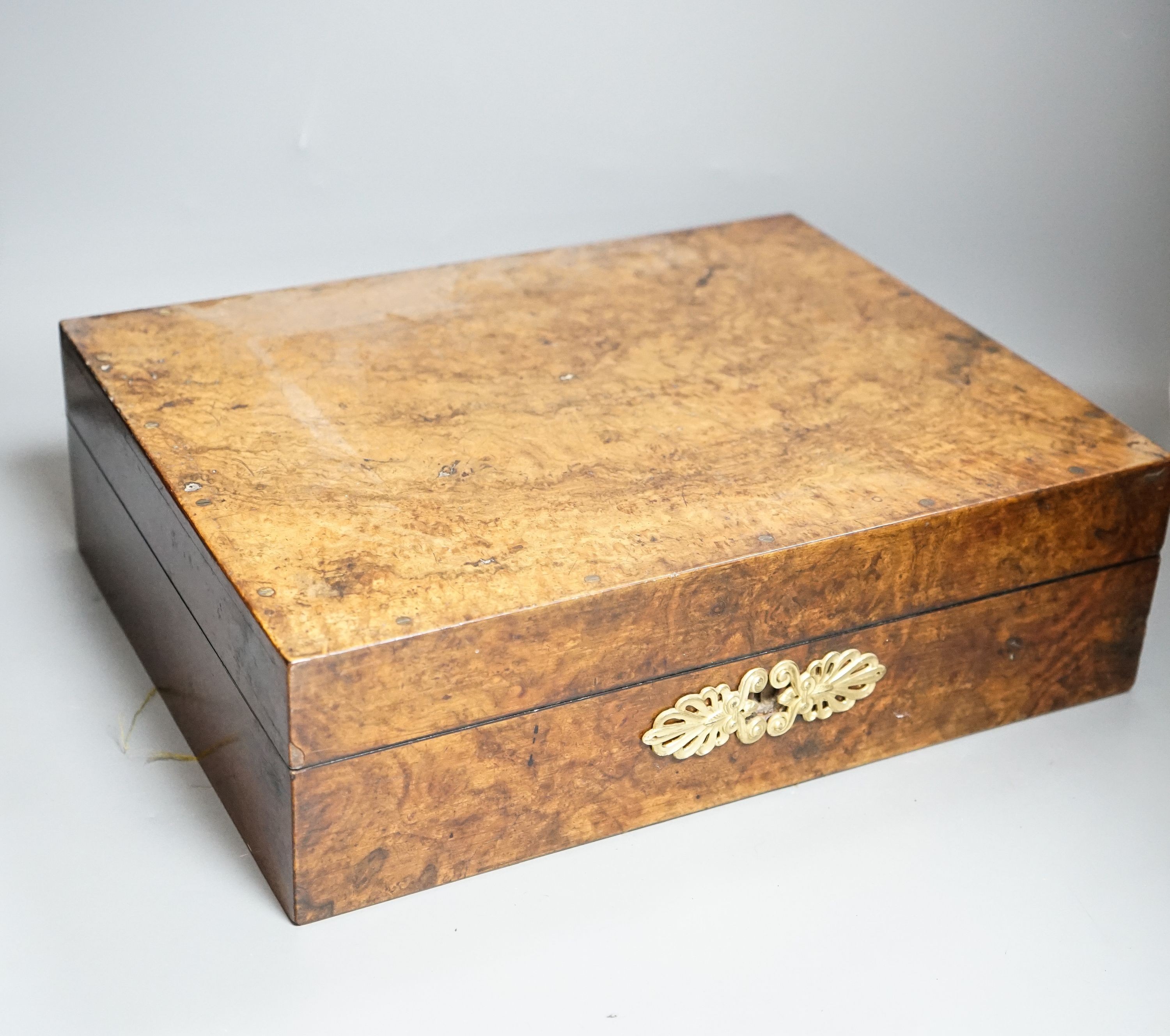 A late 19th/early 20th century brass mounted burr walnut box, label to interior reading ‘E.Gould & Son. Chemists. 32. Moorgate street. E.C. And 20 Bishops road. W. By appointment to the London Homeopathic Hospital.’
